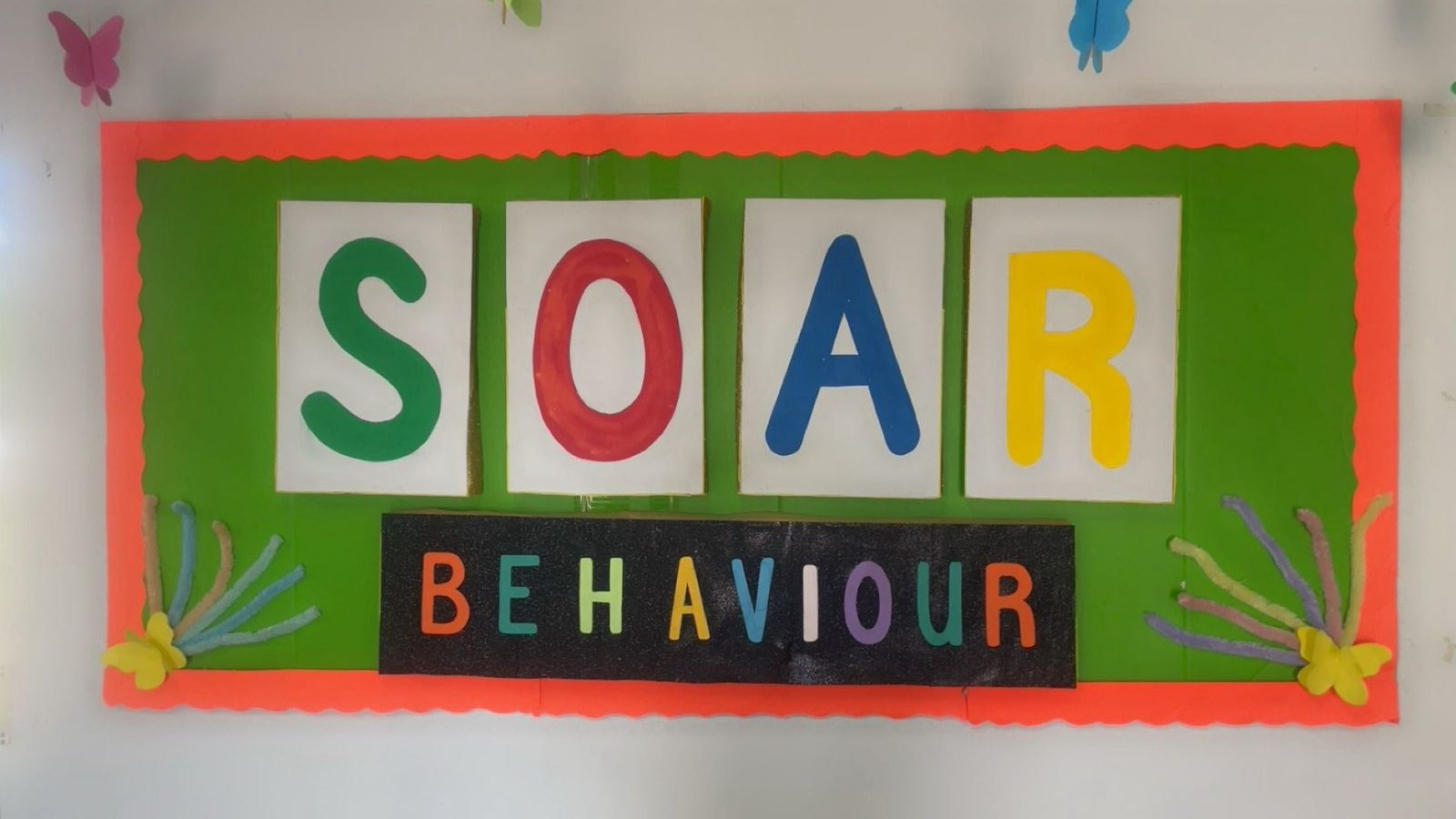 The SOAR behaviour board in our classroom — big colourful letters S, O, A, and R on a bright green board with paper butterflies